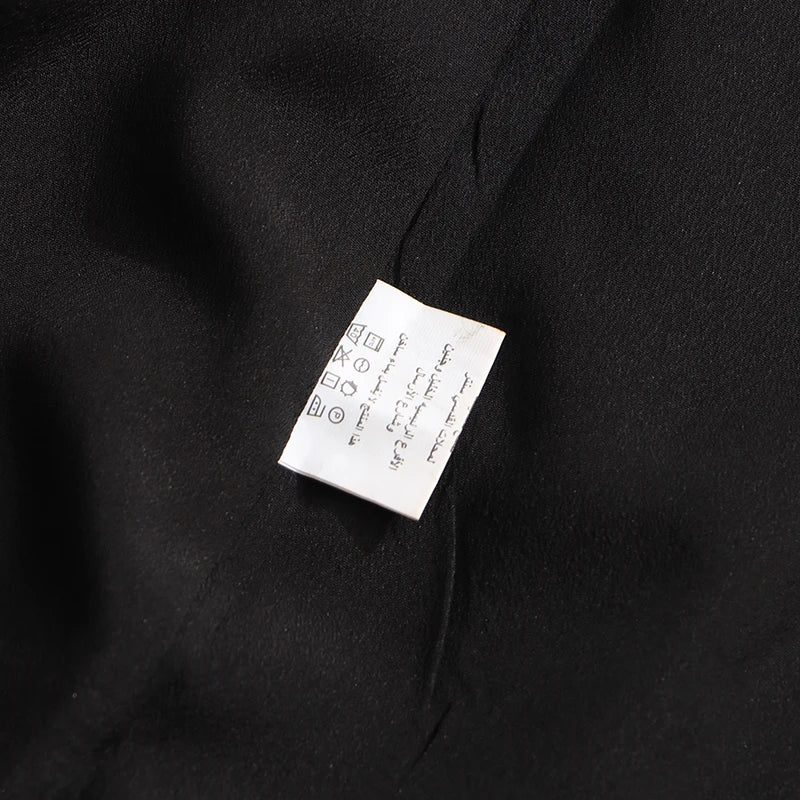 Elegantes Damenkleid mit Rundhalsausschnitt, langen Ärmeln und Patchwork-Design in lockerer Passform.