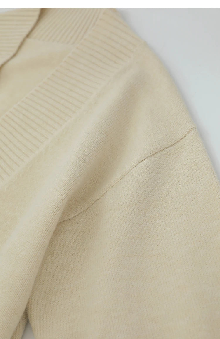 Detail Schulterbereich: cremefarbener V-Strickpullover mit feinem Rippenstrick