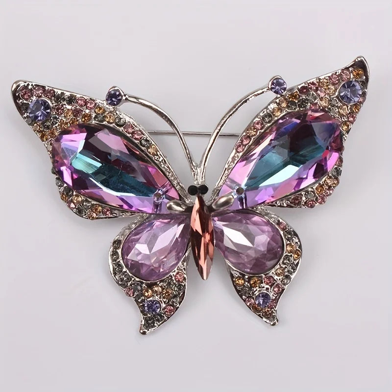 Schmetterlingsbrosche mit violetten und rosafarbenen Glitzersteinen, silberfarbenem Rand
