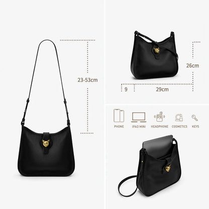 Schwarze leichte Leder-Eimer-Tasche mit goldfarbenem Katzenanhänger an der Vorderseite
