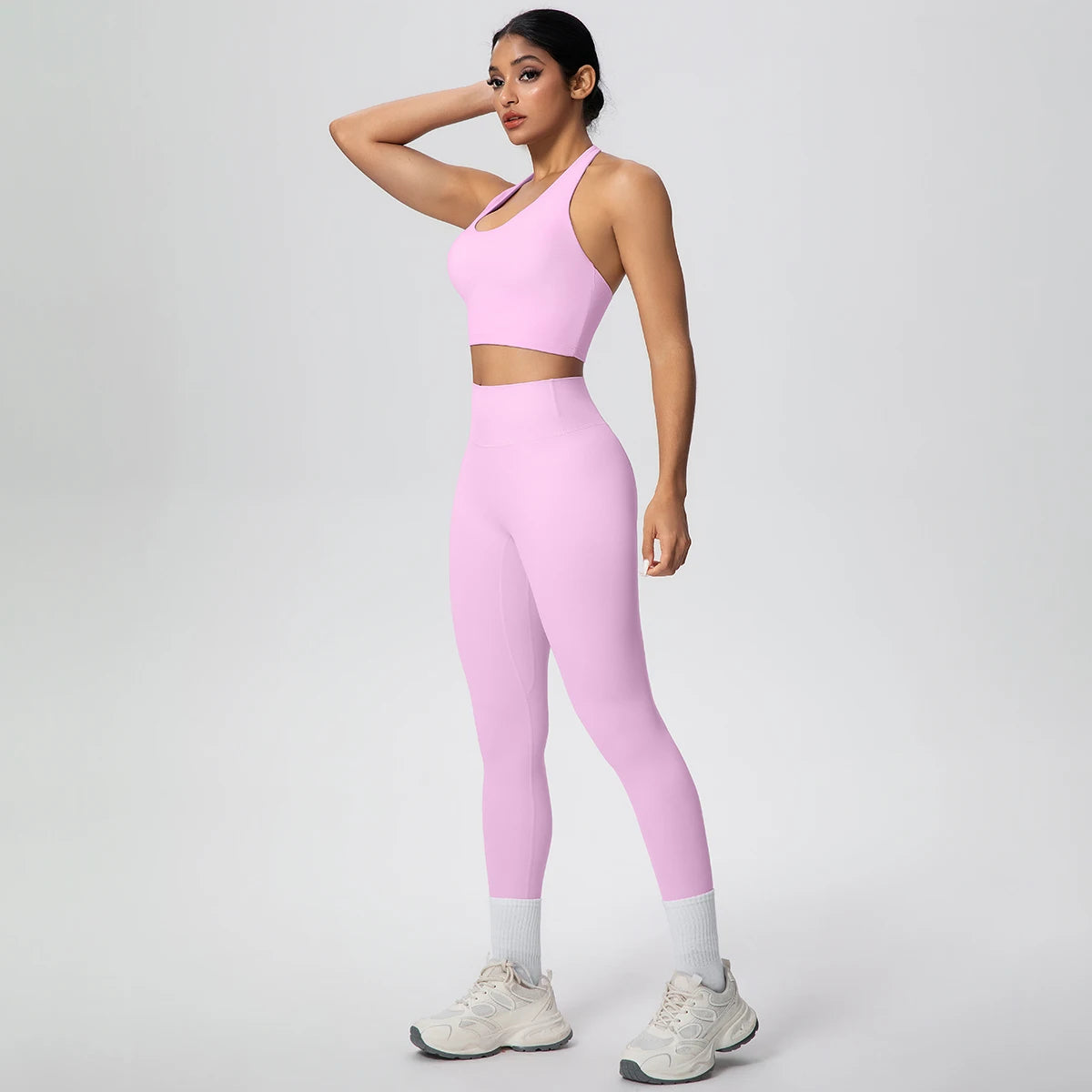 Rosa Yoga-Set: Trägertop mit kurzem Schnitt und hochbundige Leggings mit Saumeinsatz