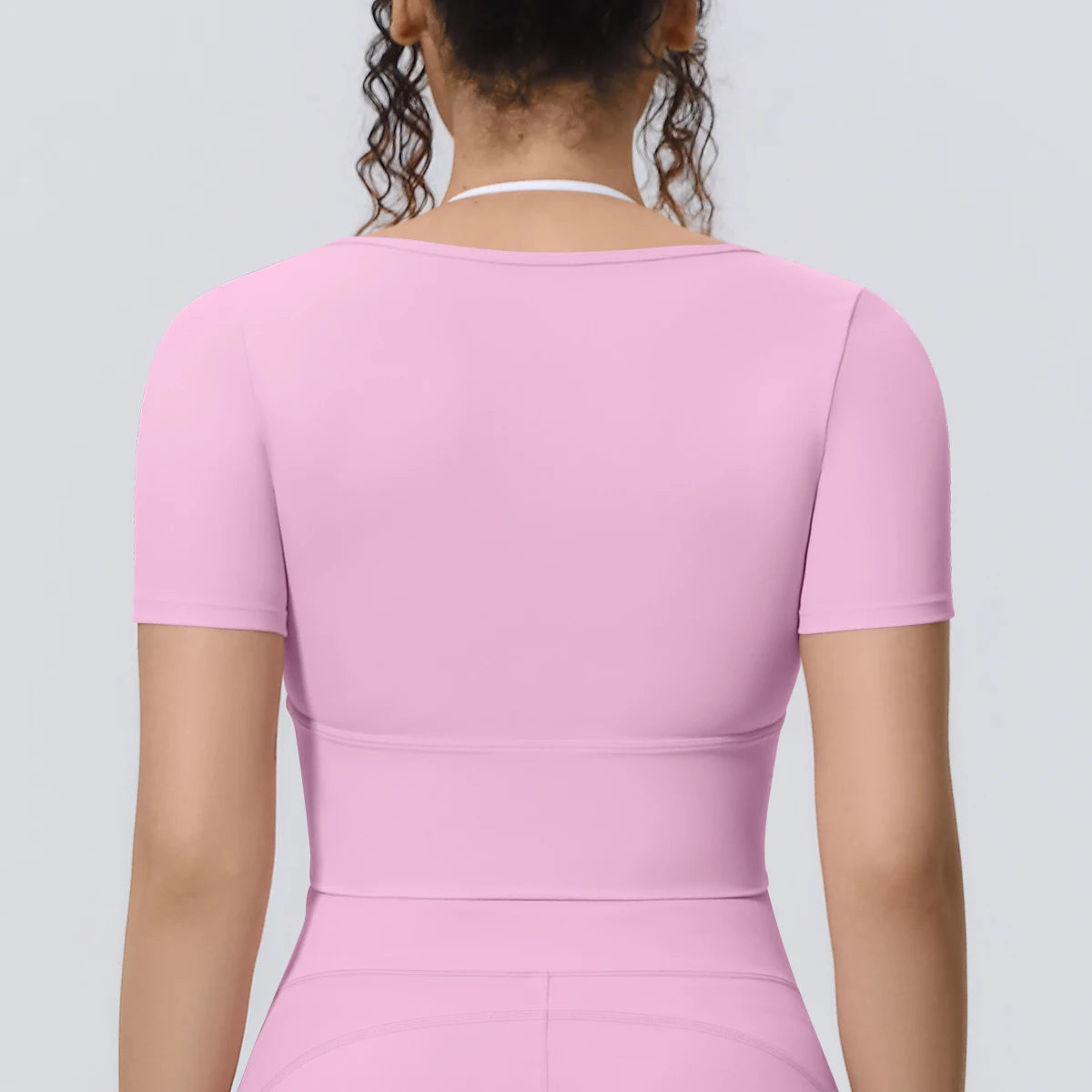 Damen Sport-T-Shirt, rosa, Rückansicht mit kurzen Ärmeln und figurbetonter Passform
