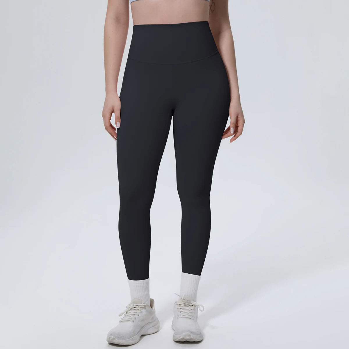 High-Waist-Yogaleggings schwarz, Vorderansicht, eng anliegend bis zum Knöchel