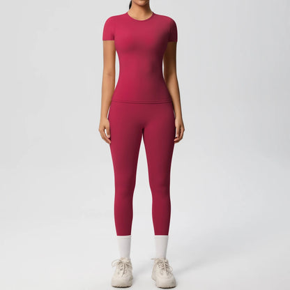 Bordeauxrotes Sport-Set aus Crop-Top und Leggings, eng anliegend, 3/4-Länge, weißer Abschluss.