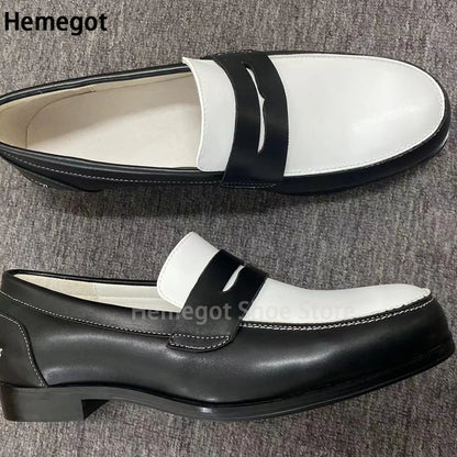 Weiße Loafer mit schwarzem Riemen, seitliche Ansicht, dicke Sohle, Lederoptik.