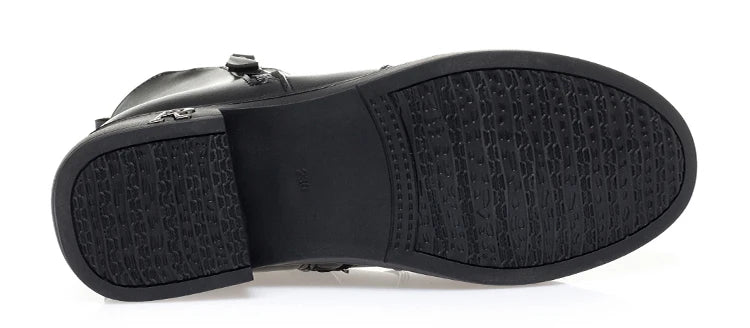 Schwarze Stiefelette mit Profilsohle, Unterseite sichtbar.