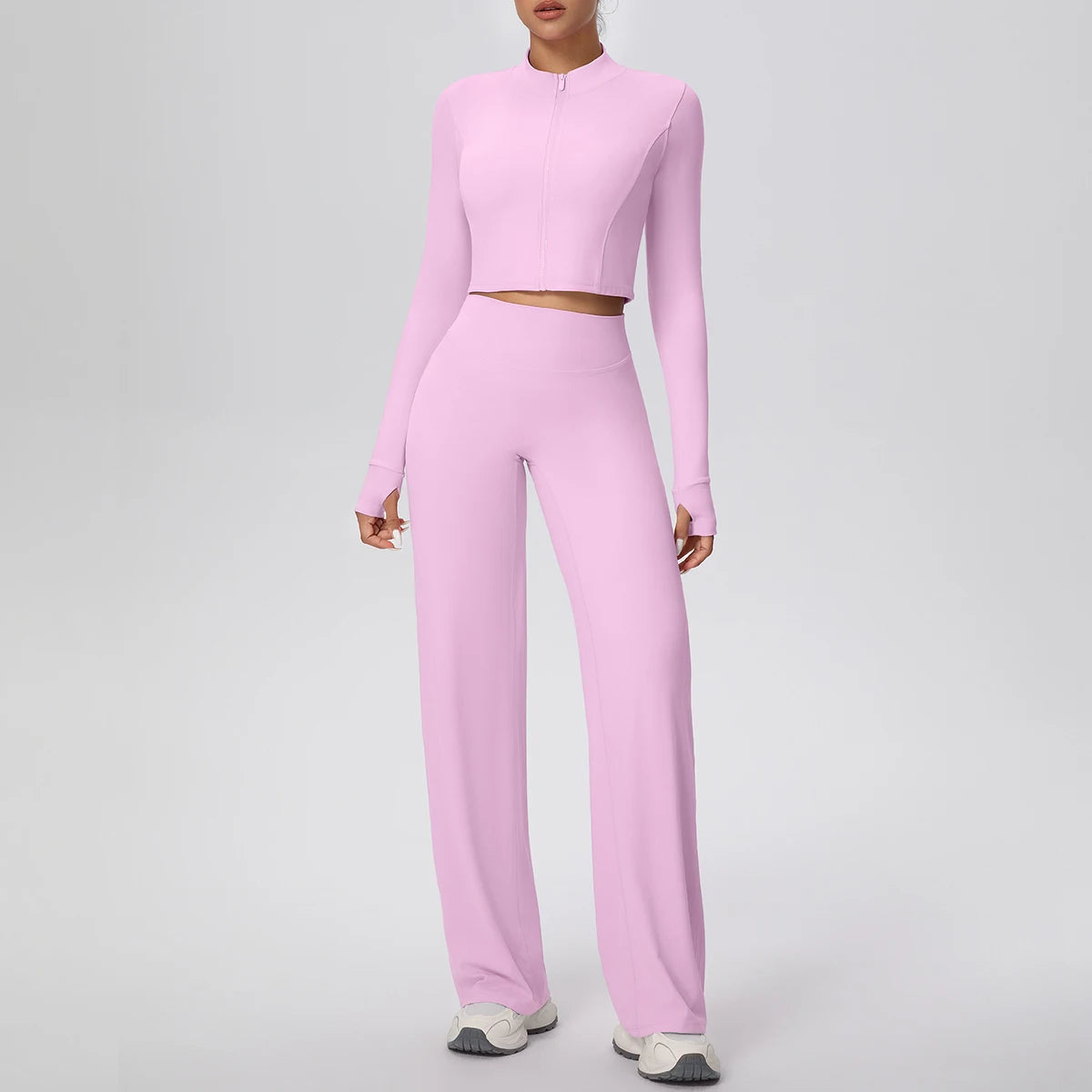 Hellrosa Yoga-Set mit Reißverschluss-Crop-Top und High-Waist-Hose, lange Ärmel.