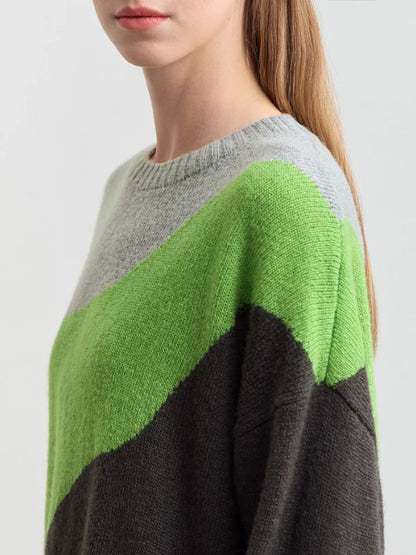 Nahaufnahme Strickpullover: diagonaler Kontrast in Hellgrün und Dunkelgrau