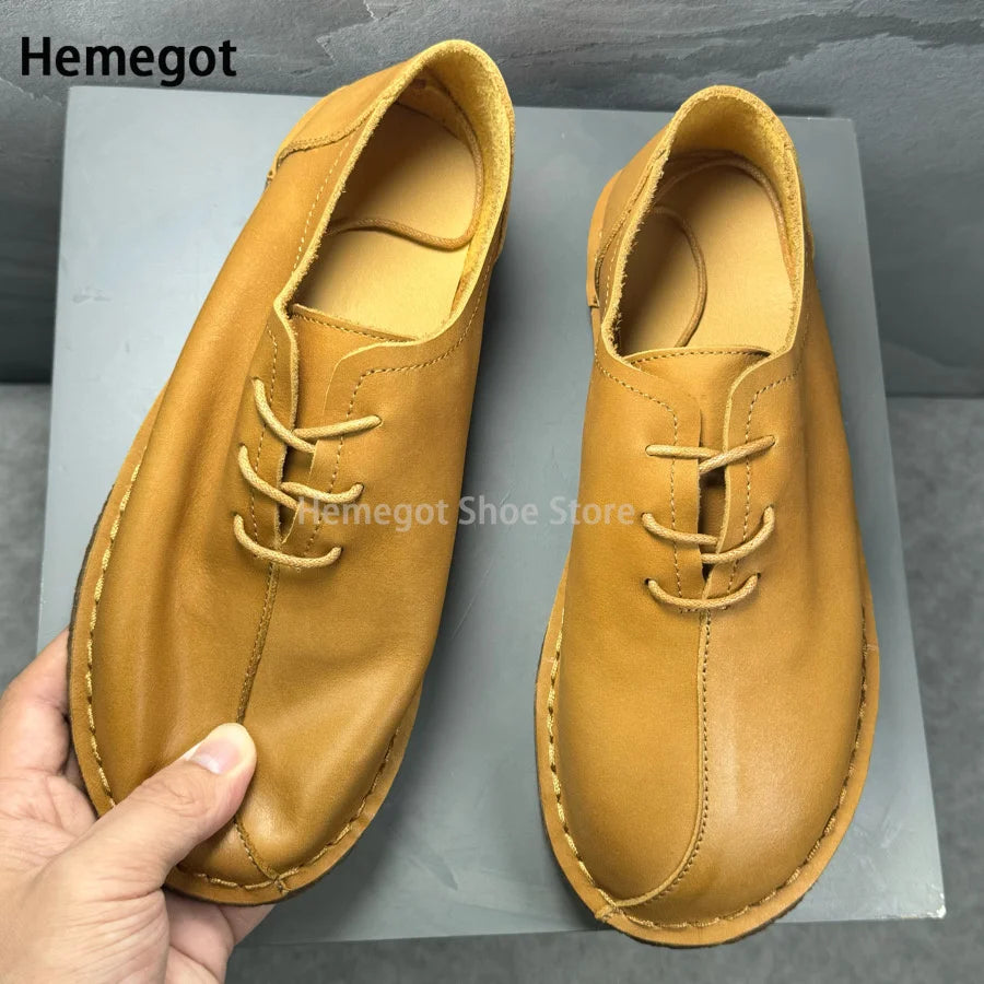 Herren-Lederschuhe in Senfgelb, Vorderansicht mit Schnürsenkeln und Steppnähten