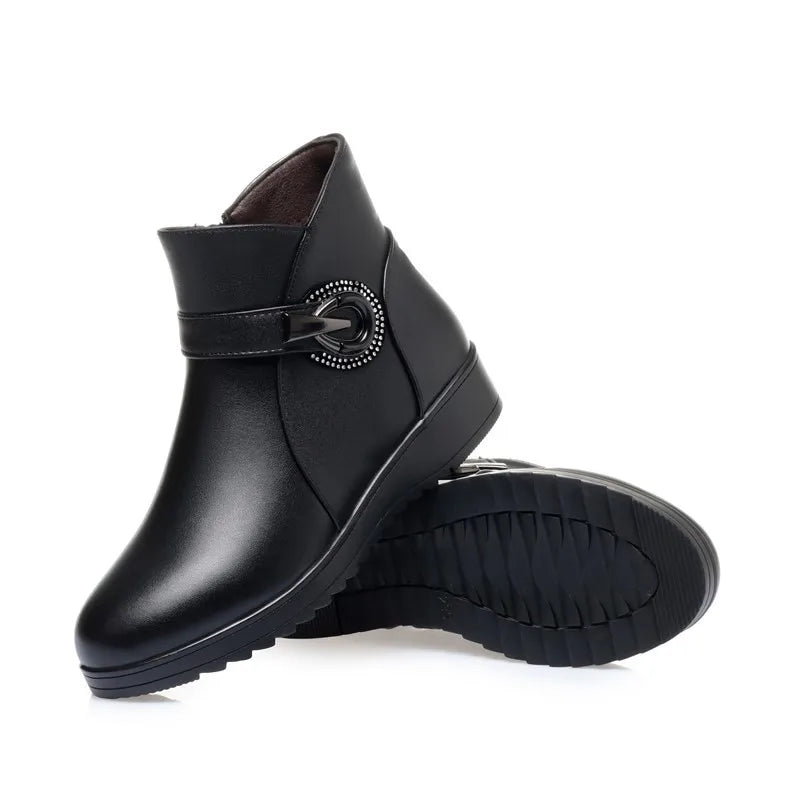 Schwarze Winterstiefelette mit Wollkragen, seitlicher Schnalle und Profilsohle