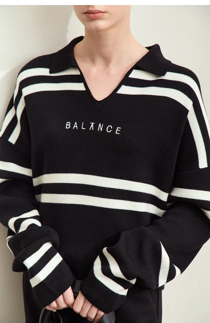 Schwarzer Damenpullover mit weißen Streifen und Buchstabenstickerei „BALANCE“, Detailaufnahme