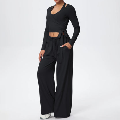 Damen-Sportset mit Wickeloberteil und weiter Langarmhose, schwarz, mit Bindegürtel