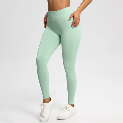 Nahtlose High-Stretch-Leggings mintgrün, seitliche Vorderansicht bis zum Knöchel