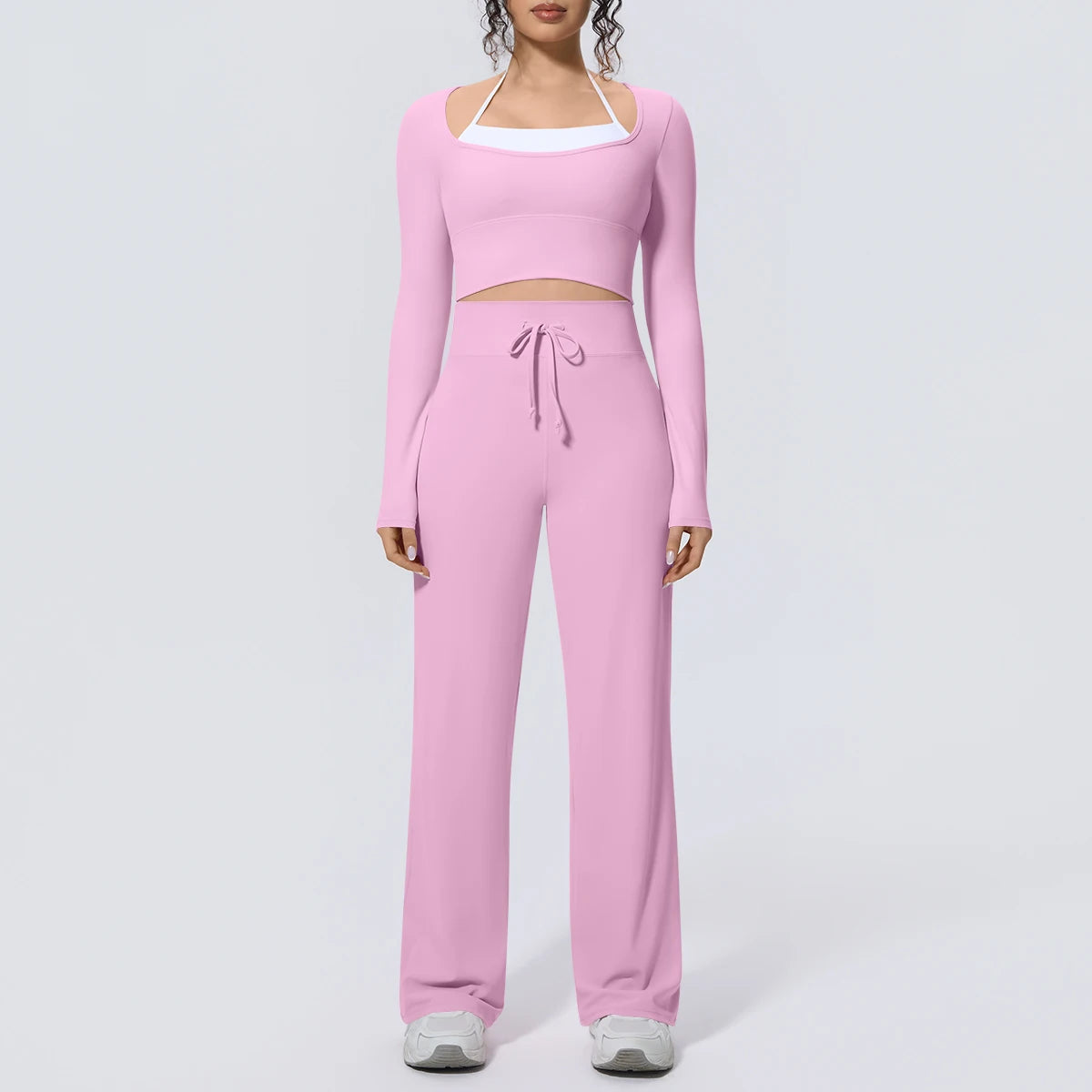Helles rosa Yoga-Set: langarmiges Crop-Top und weite Hose mit Kordel an der Taille
