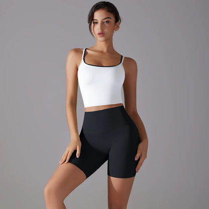 Schwarzes Yoga-Set mit weißem Crop-Top und kurzen Leggings, frontnah
