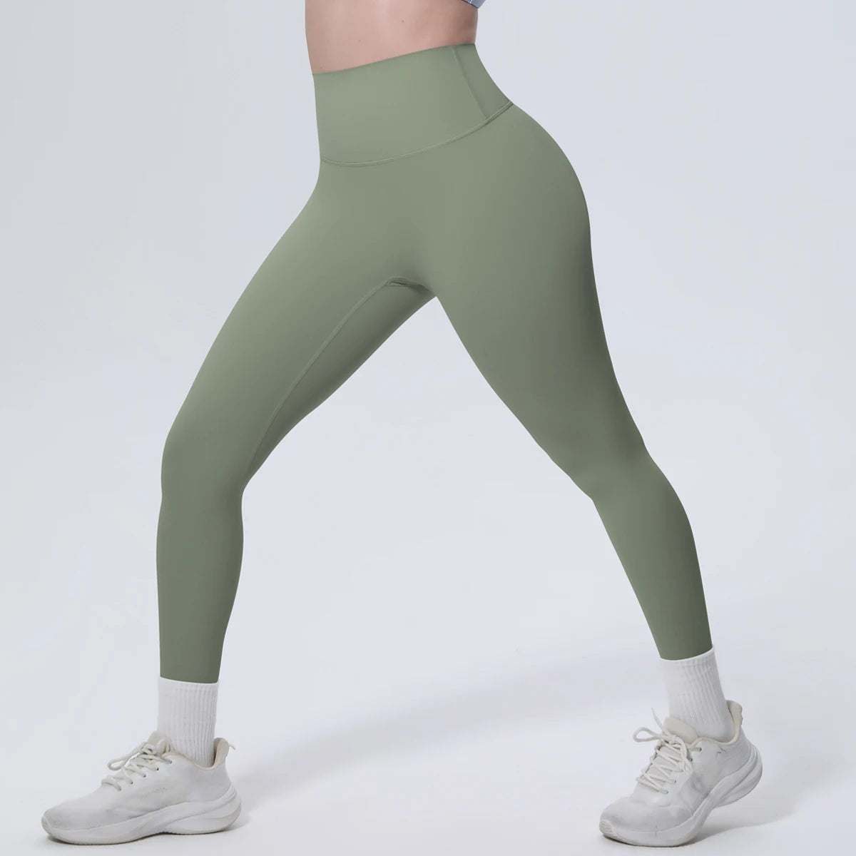 High-Waist-Yogaleggings olivgrün, Nahansicht seitlich, glatte Oberfläche ohne Muster