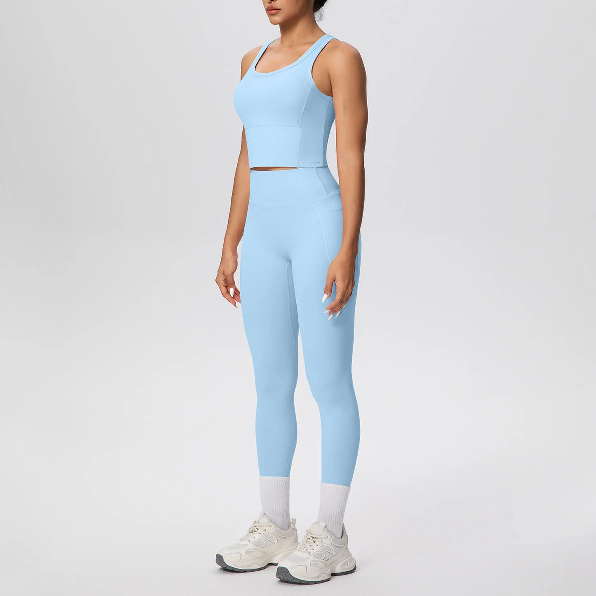 Damen-Yoga-Set in Hellblau: ärmelloses Crop-Top mit High-Waist Leggings und Kontrastknöcheln