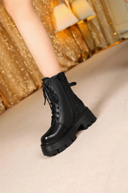 Schwarze Stiefelette mit Schnürung und Plateau-Chunky-Sohle, schräger Blick nach vorn
