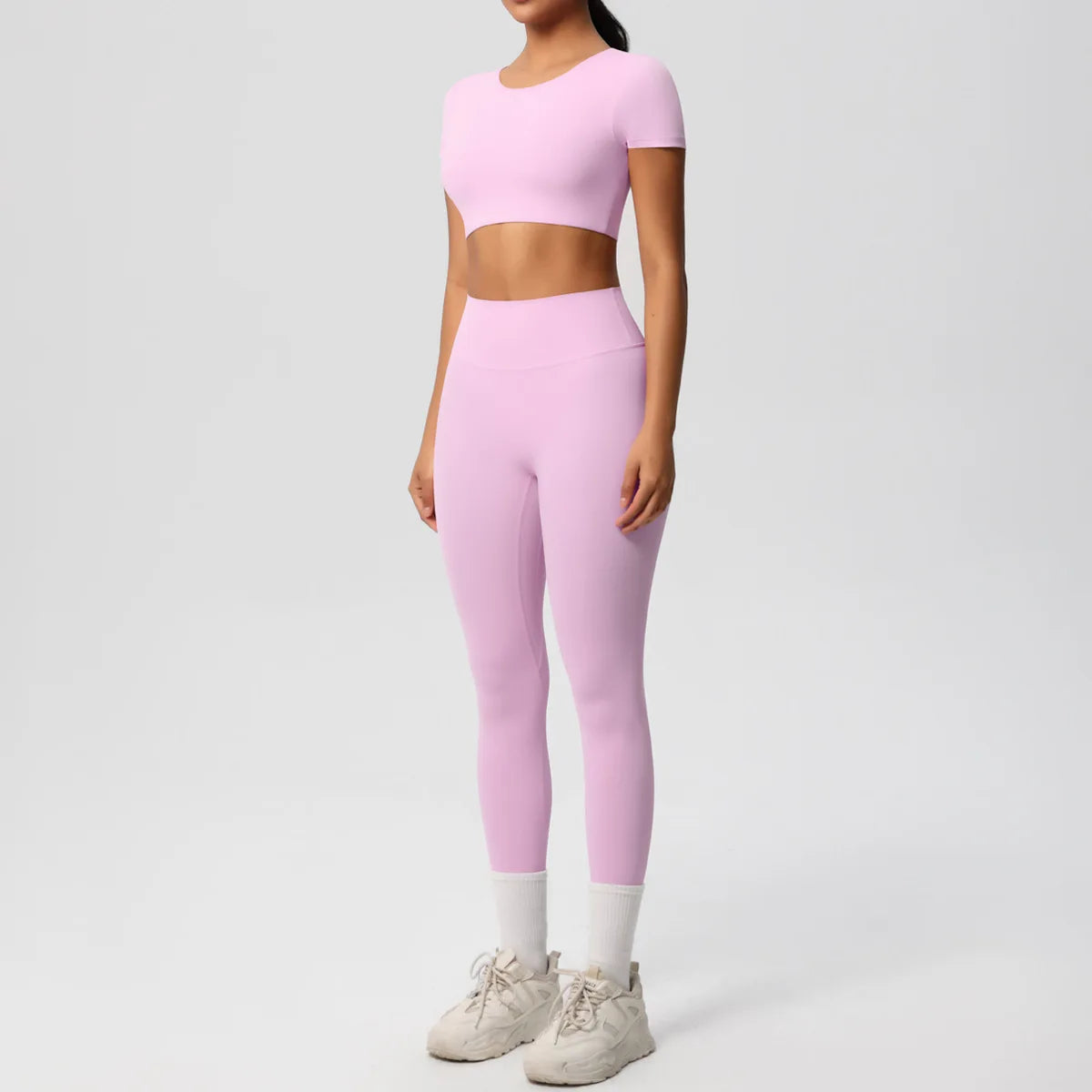 Yoga-Set für Damen: Crop-Top und High-Waist-Leggings, hellrosa, Frontansicht.