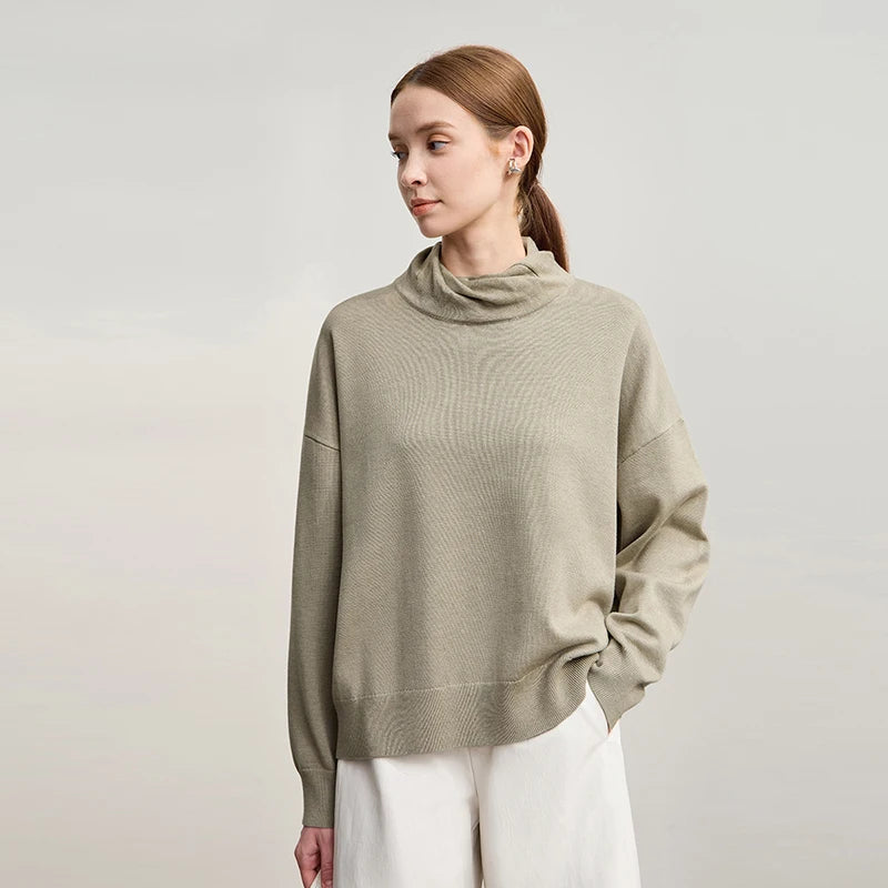 Beiger Rollkragenpullover mit Bündchen, darunter weiße Shorts