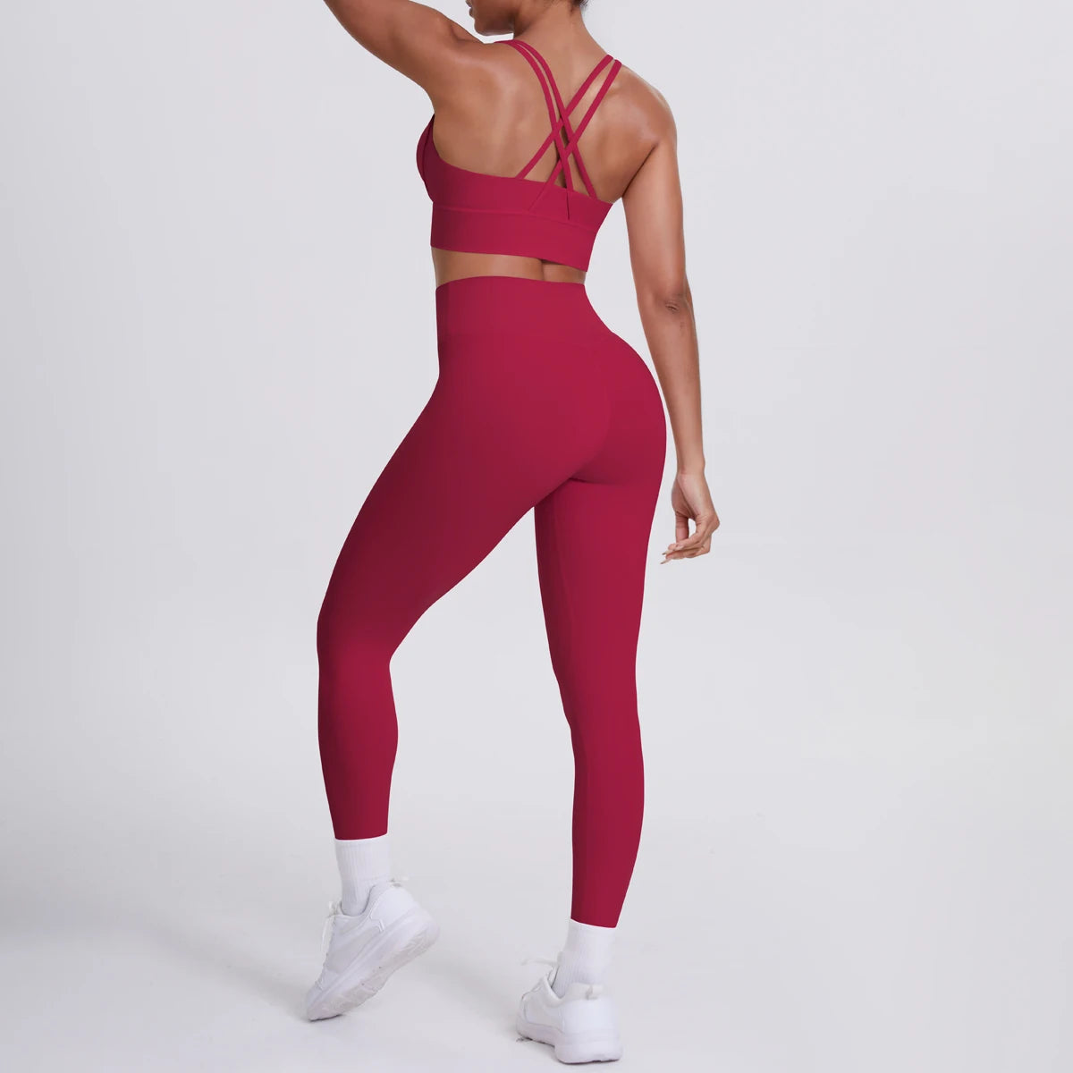 Yoga-Set: dunkelrote High-Waist Fitnesshose mit Sport-BH hinten, gekreuzte Träger
