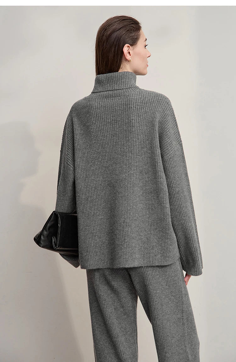Grauer Rollkragenpullover von hinten, dazu graue weite Hose
