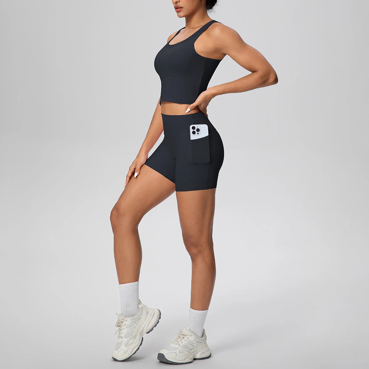 Damen Fitness-Set aus Weste und Laufshorts, dunkelblau, Seitenansicht mit Taschenfach