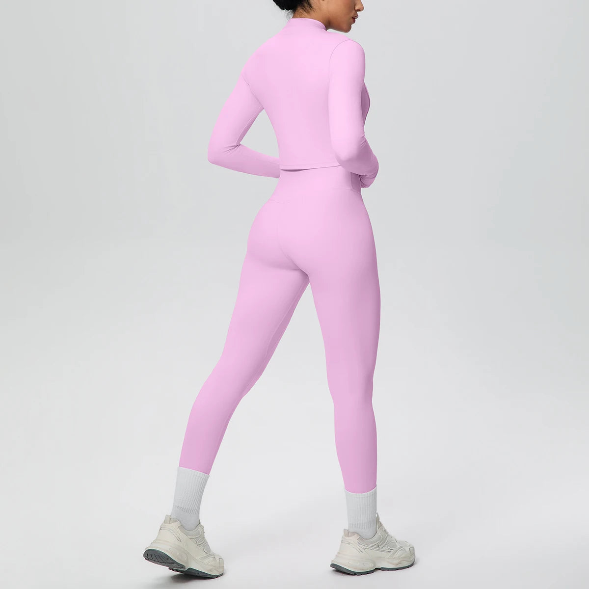 Rosa Yoga-Set: Zip-Top und High-Waist-Leggings, seitliche Ansicht