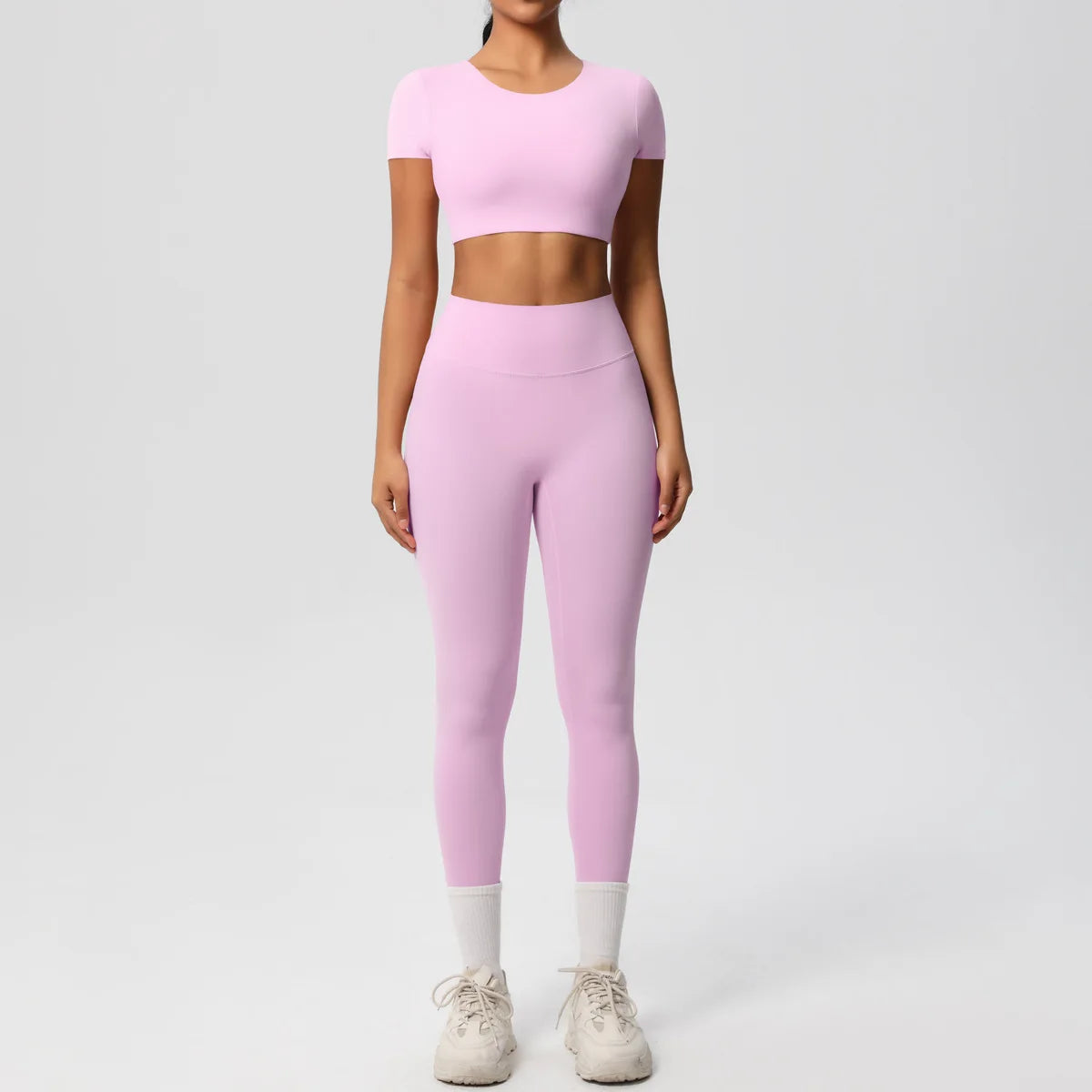 Yoga-Set für Damen: Crop-Top und High-Waist-Leggings, hellrosa, Ganzkörperansicht.