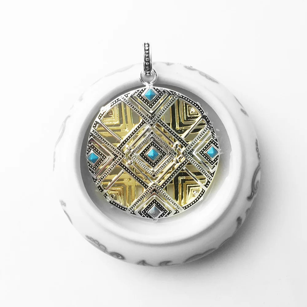 Vorderansicht: runder Anhänger mit goldfarbenem Mosaik-Design und blauen Schmuckeinsätzen